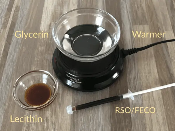 A mug warmer is shown with a clear bowl to Warm the RSO / FECO with lecithin and glycerin before adding them to your recipe.