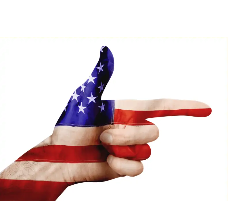 A man's hand pointed like a gun. The hand is colored like the American Flag. 