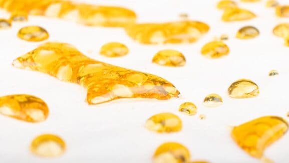 This photo depicts golden colored cannabis concentrates often times known as shatter.
