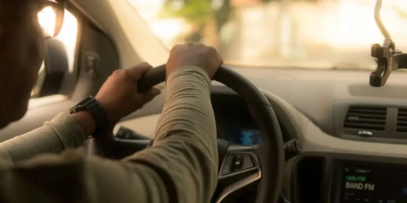 This image depicts a person behind the wheel of a car, something that is not recommended after taking CBD oil.