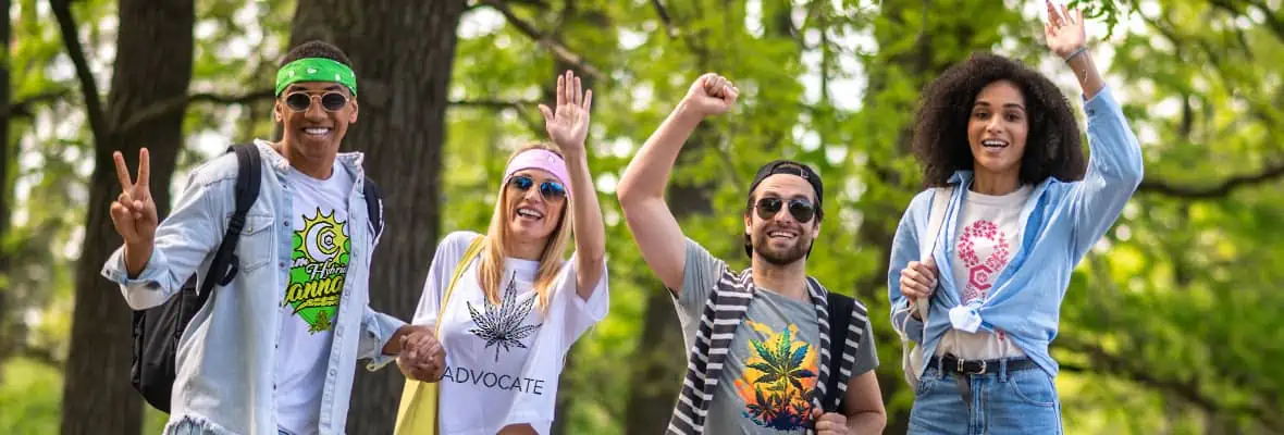 a group of people from the cannabis community wearing cannabis clothing are standing next to each other, waving at you.