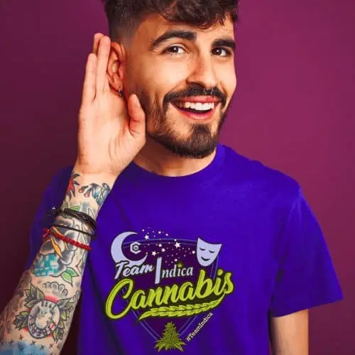 a man wearing a purple t-shirt with a tattoo on his ear in the Cannabis Community.