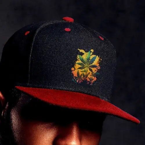 A man sporting a stylish black and red snapback hat adorned with a captivating floral design, embodying the essence of cannabis apparel.