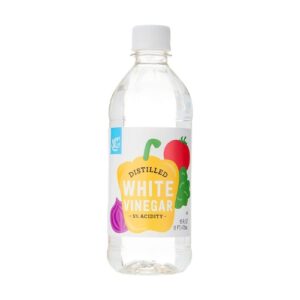 A bottle of water with vegetables on it.