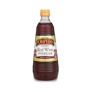 A bottle of red wine vinegar on a white background.