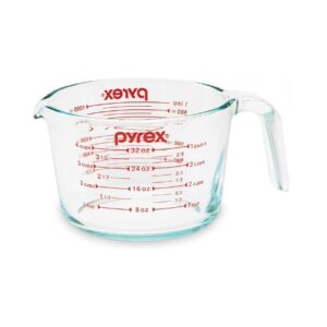 A glass measuring cup with the word pyrex on it.