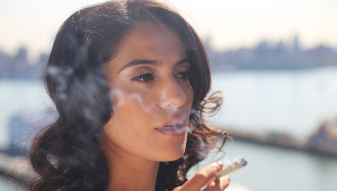 A woman in Florida smokes a cannabis joint as a legal medical cannabis patient under Amendment 2.