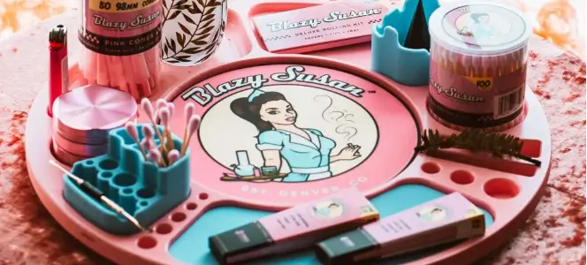 A Pink Blazy Susan Lazy Susan Rolling tray with cute pink lighter, pink rolling papers, pink grinder and pink cones.
