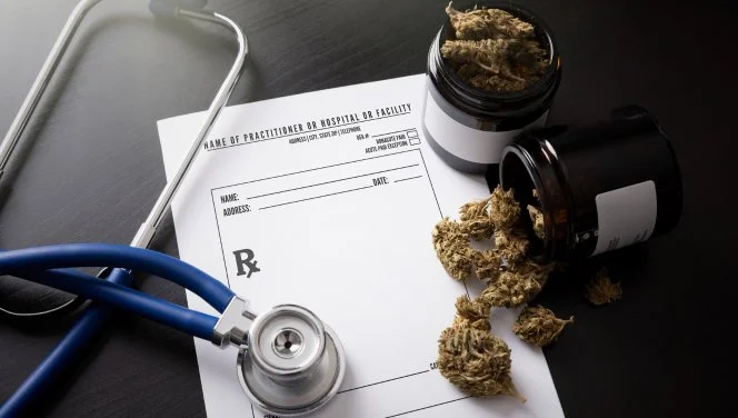 Medical marijuana certification with a blue stethoscope and Pennsylvania medical cannabis flower on the table. 