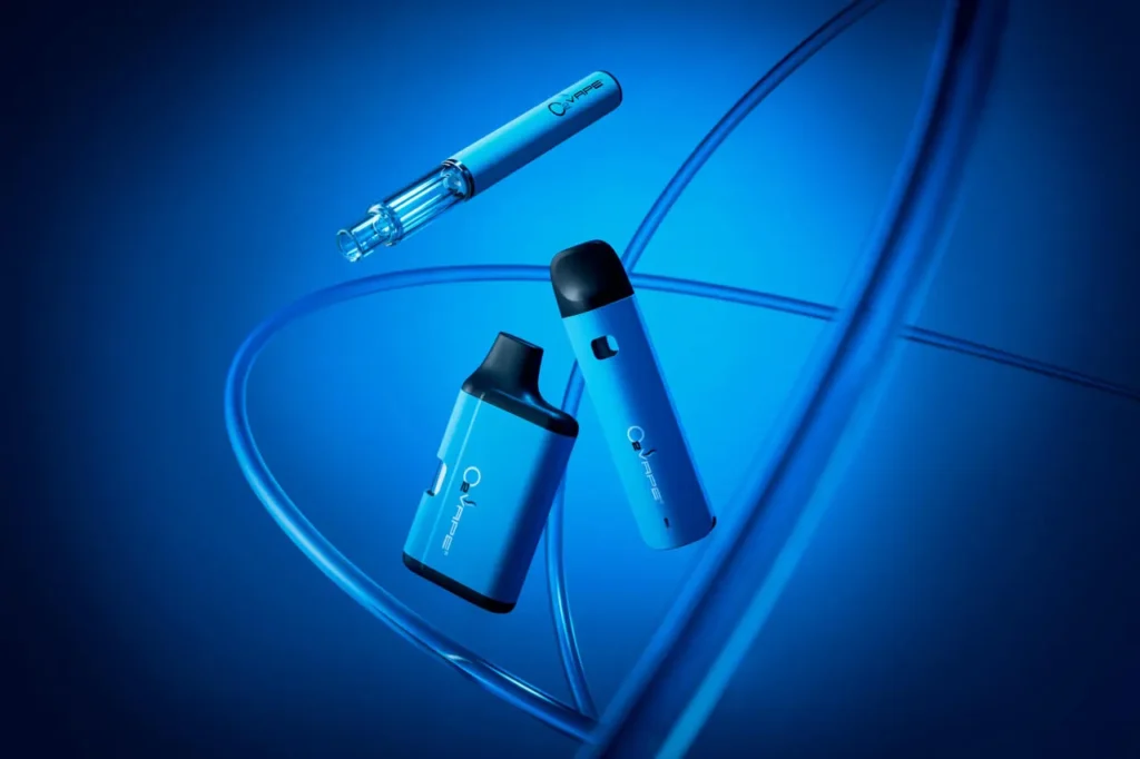 Three sleek blue vaping devices float against a vibrant blue background, with curved lines adding dynamic motion to the composition. Showcasing O2VAPE's minimalist vape hardware, the devices are arranged in a striking triangular formation.